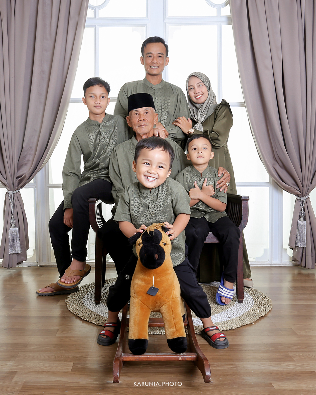 Parents holding their newborn baby in a cozy home setting with soft natural light filtering through curtains
