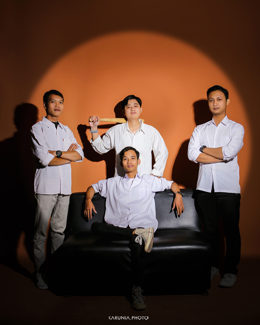 Sports team in uniform posing with championship trophy on field after winning game