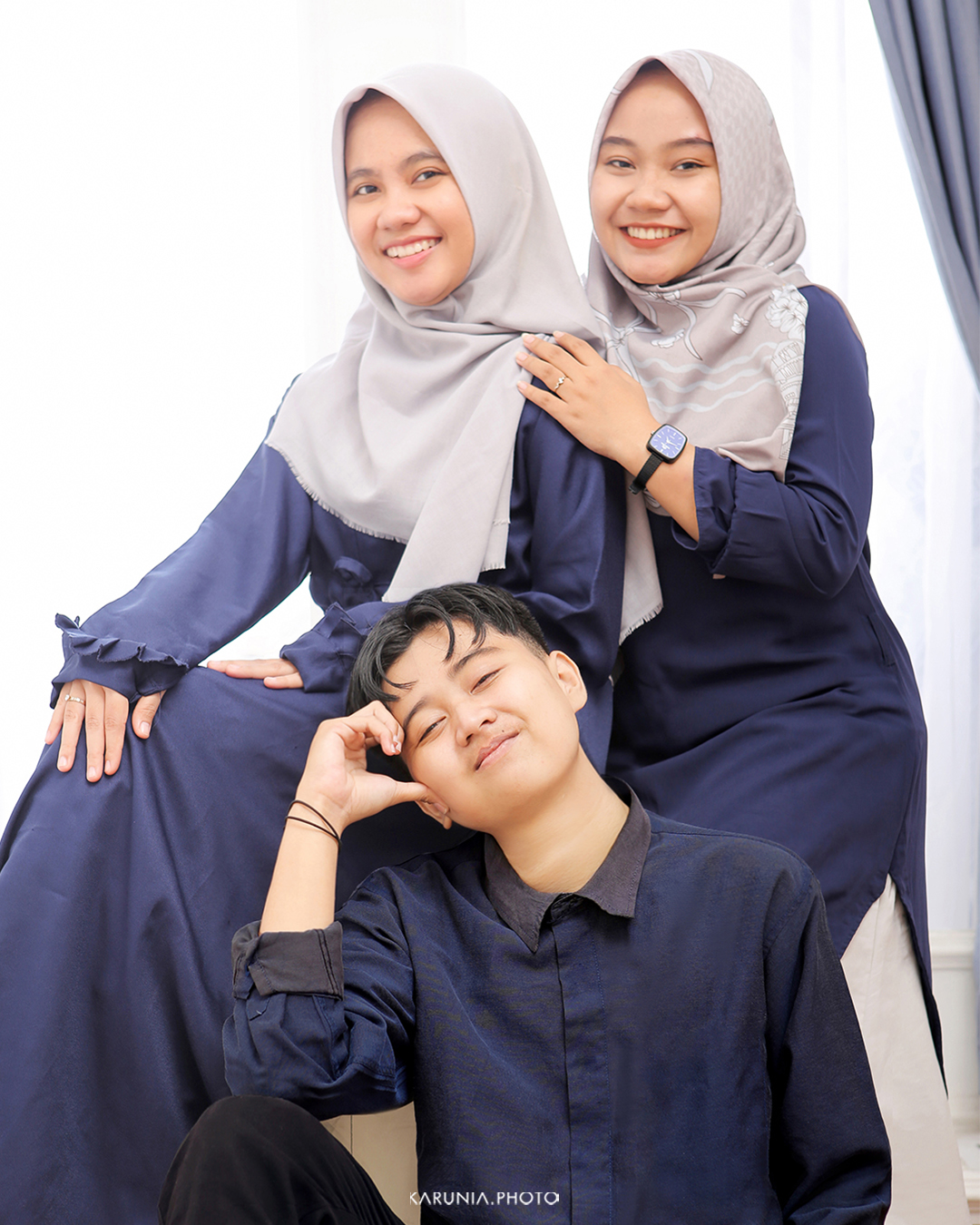 Sports team in uniform posing with championship trophy on field after winning game