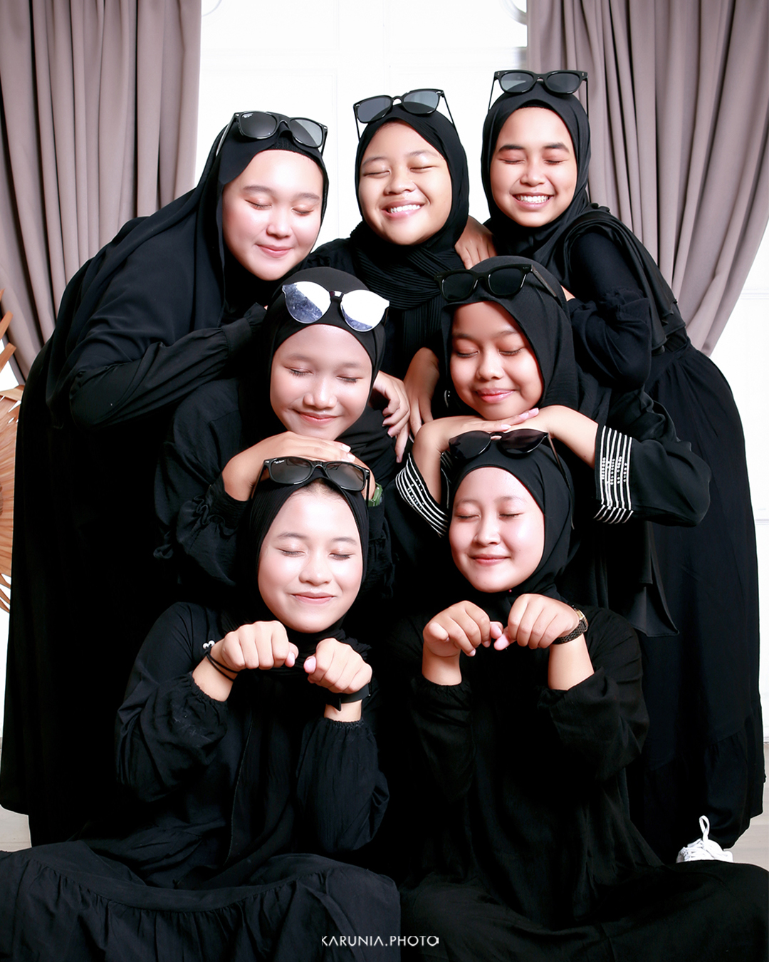Corporate team of 15 people arranged in stadium seating with professional lighting in modern office