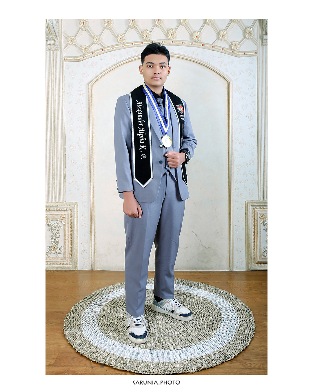 Group of friends in caps and gowns cheering together with arms around each other