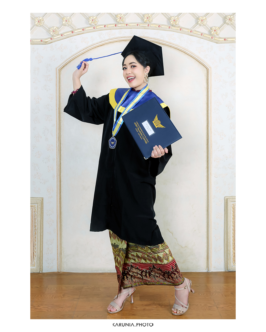 Graduate tossing cap in the air with confetti falling around them on university steps