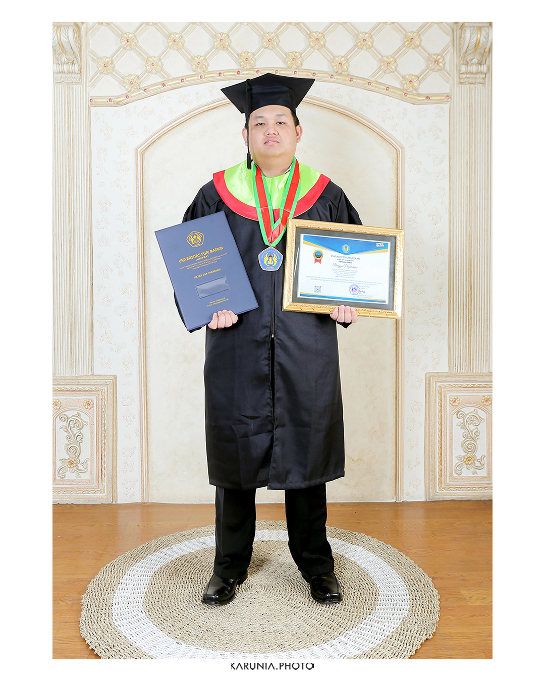 Close-up portrait of graduate holding diploma with proud expression and family in background